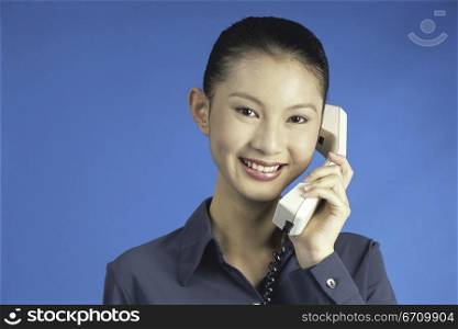 Portrait of a businesswoman talking on a telephone.
