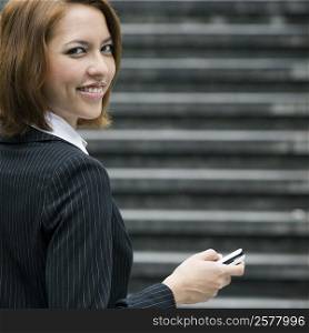 Portrait of a businesswoman text messaging
