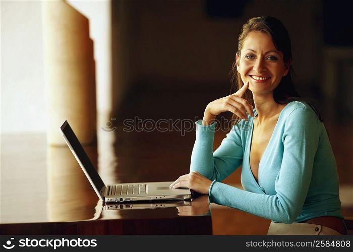 Portrait of a businesswoman typing on a laptop