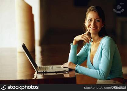 Portrait of a businesswoman typing on a laptop