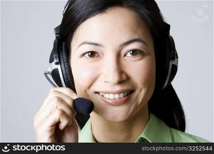 Portrait of a businesswoman using a headset and smiling