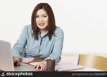 Portrait of a businesswoman using a laptop