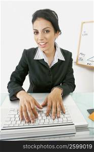 Portrait of a businesswoman using a laptop and smiling