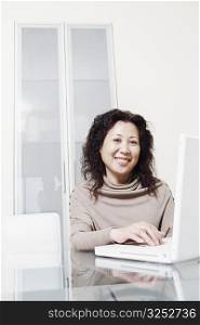 Portrait of a businesswoman using a laptop smiling