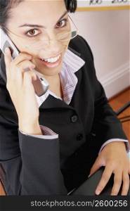 Portrait of a businesswoman using a mobile phone and smiling