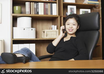 Portrait of a businesswoman using a mobile phone smiling