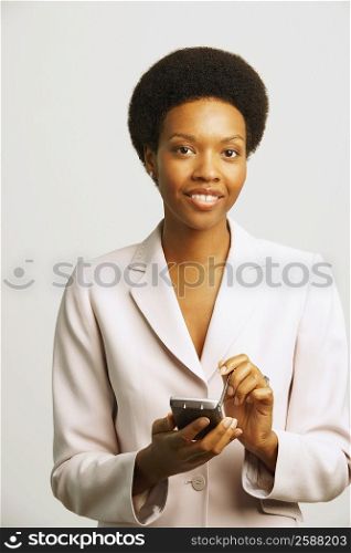 Portrait of a businesswoman using a personal data assistant