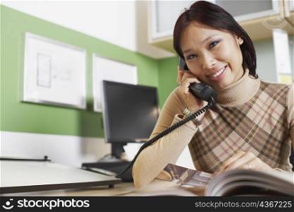 Portrait of a businesswoman using a telephone
