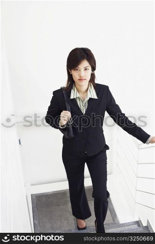 Portrait of a businesswoman walking up a staircase