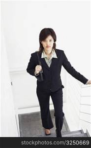 Portrait of a businesswoman walking up a staircase