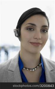 Portrait of a businesswoman wearing a hands free device and smiling