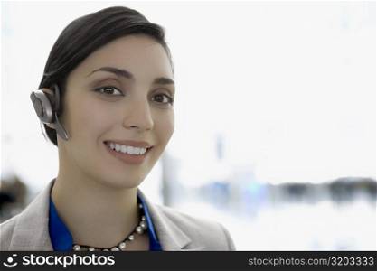 Portrait of a businesswoman wearing a hands free device and smiling