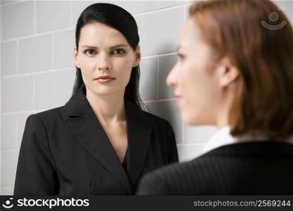 Portrait of a businesswoman with another businesswoman standing in front of her