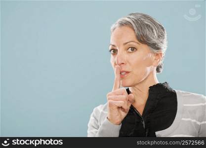 Portrait of a businesswoman with finger on lips