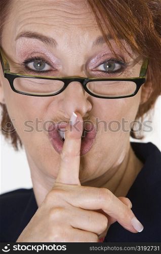 Portrait of a businesswoman with her finger on her lips