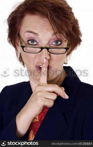 Portrait of a businesswoman with her finger on her lips