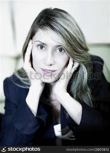 Portrait of a businesswoman with her hands on her chin