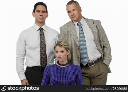 Portrait of a businesswoman with two businessmen standing behind her
