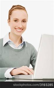 Portrait of a businesswoman working on a laptop and smiling