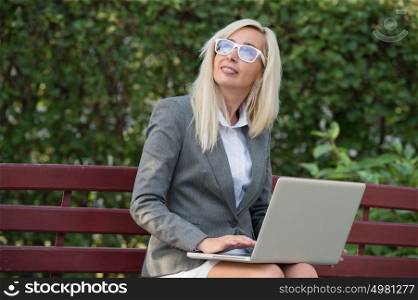 Portrait of a businesswoman working outdoors on laptop