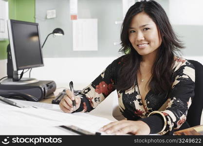 Portrait of a businesswoman writing with a pen