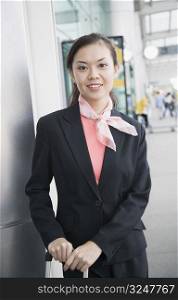 Portrait of a cabin crew standing at an airport and smiling