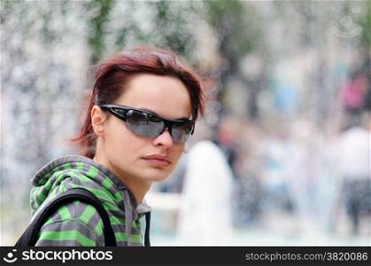 Portrait of a casual candid girl with sunglasses on street ,nice bokeh