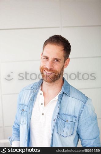 Portrait of a casual guy with denim shirt in the street