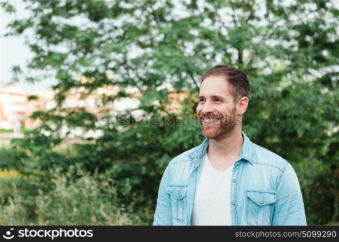 Portrait of a casual men with denim shirt in a park