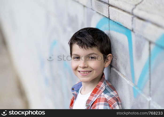 portrait of a casual teen boy, outdoors