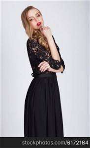 Portrait of a casual young fashion model posing in a black dress.