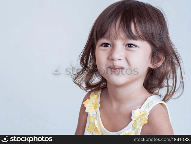 Portrait of a caucasian little girl is smiling. There is a copy space on the left side
