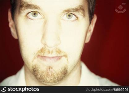 Portrait Of A Caucasian Man Looking Into A Bright Light