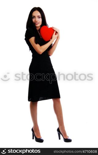 Portrait of a charming young girl on a white background holding a heart