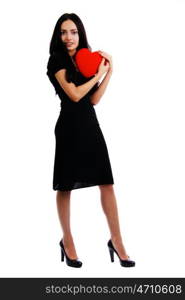 Portrait of a charming young girl on a white background holding a heart