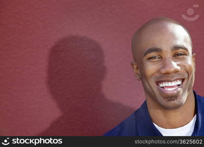 Portrait of a cheerful African American man over colored background