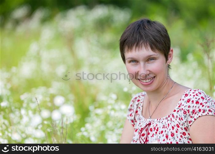 Portrait of a cheerful caucasian on chamomile background