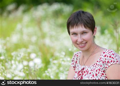 Portrait of a cheerful caucasian on chamomile background
