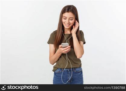 Portrait of a cheerful cute woman listening music in headphones and dancing isolated on a white background. Portrait of a cheerful cute woman listening music in headphones and dancing isolated on a white background.