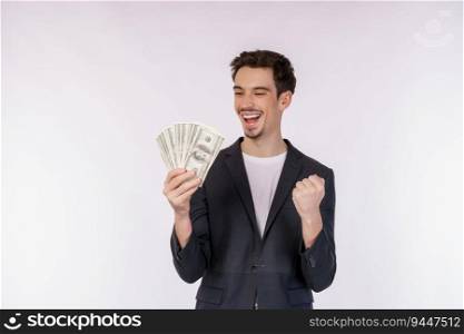 Portrait of a cheerful man holding dollar bills and doing winner gesture clenching fist over white background. Finance, investment and money saving concept.