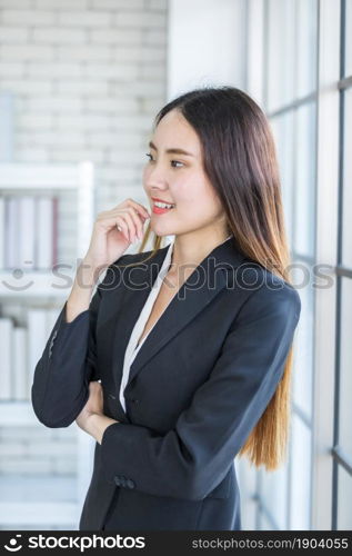 Portrait of a cheerful mature Asian businesswoman at In the office room background,business expressed confidence embolden and successful concept