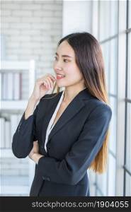 Portrait of a cheerful mature Asian businesswoman at In the office room background,business expressed confidence embolden and successful concept