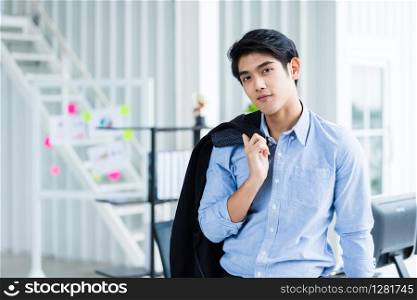 Portrait of a cheerful mature businessman at In the office room background.