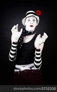 Portrait of a cheerful mime on a black background