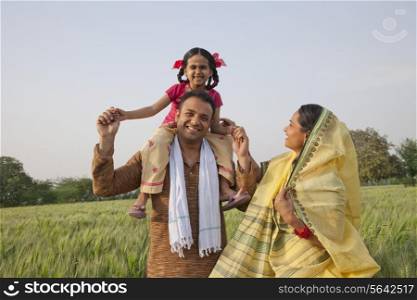 Portrait of a cheerful rural family in the field