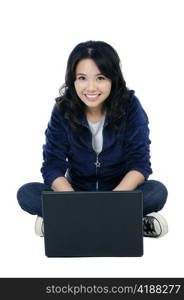 Portrait of a cheerful woman sitting on floor with a laptop.