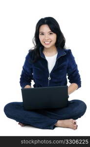 Portrait of a cheerful woman sitting on floor with laptop