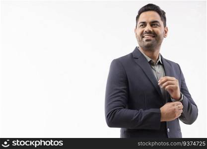 Portrait of a cheerful young businessman in formal outfit looking elsewhere