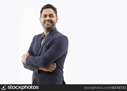 Portrait of a cheerful young businessman looking elsewhere with hands folded