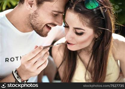 Portrait of a cheerful, young couple eating a lunch